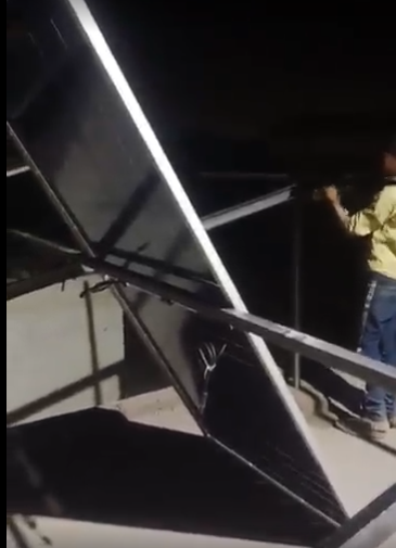 Solar panel frame installation during night work in Lahore